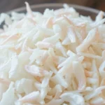Premium dehydrated white onion flakes displayed in a bowl for culinary use, emphasizing quality